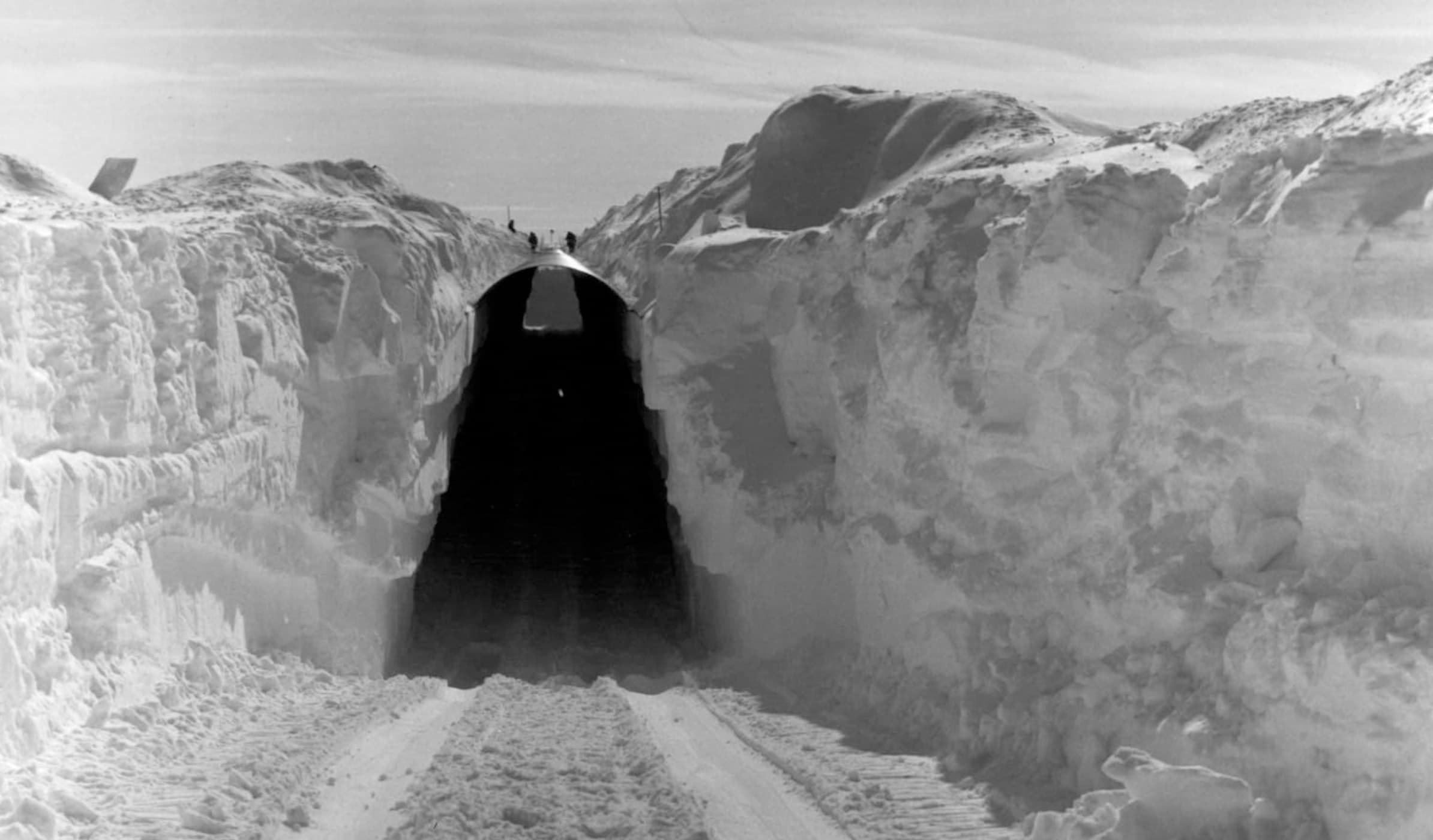 A colossal tunnel meticulously carved through thick layers of Arctic snow.