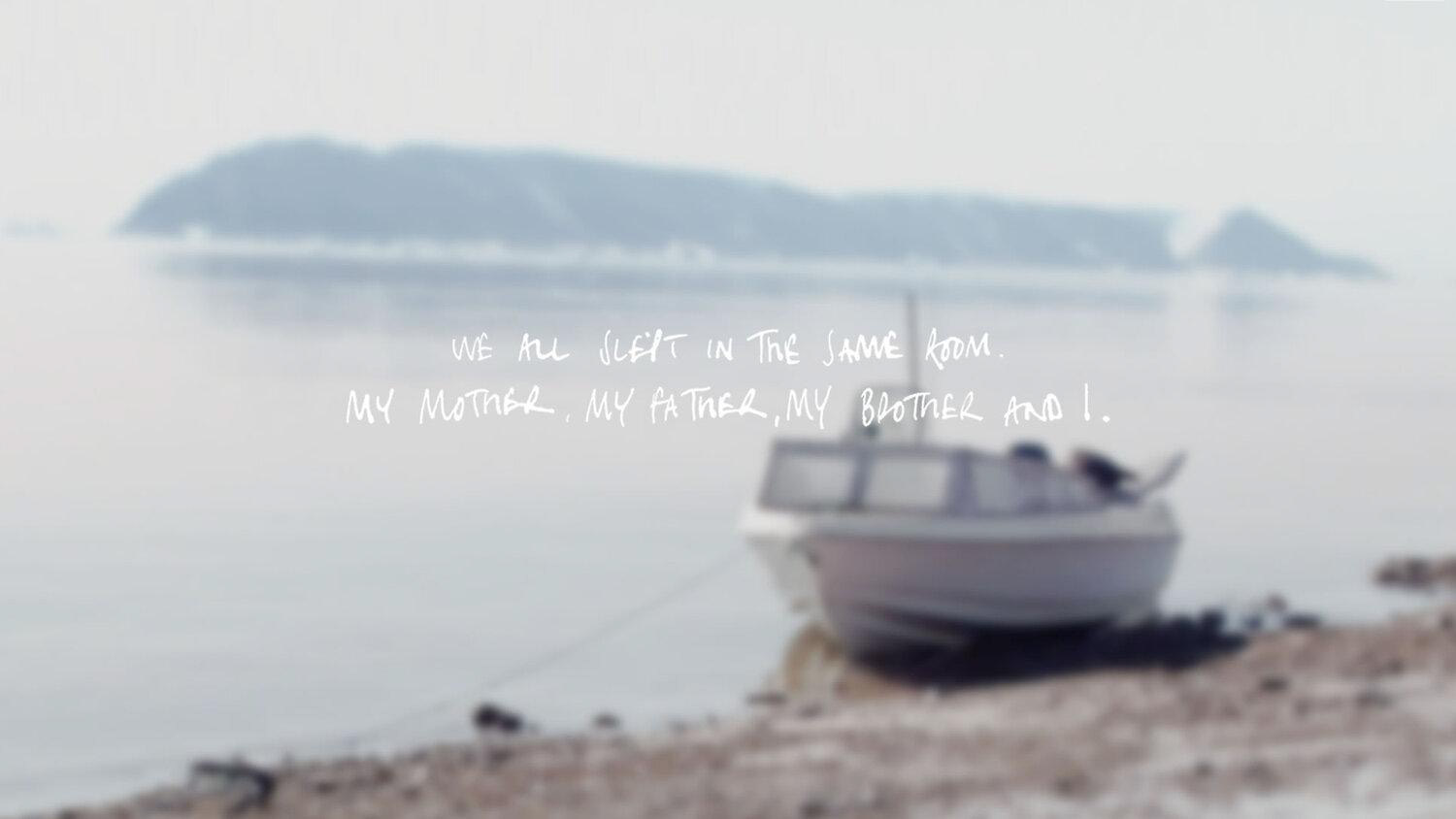 A screenshot showing a boat sitting on the shore next, with hand-written words shown on top saying 'We all slept in the same room, my mother, my father, my brother and I