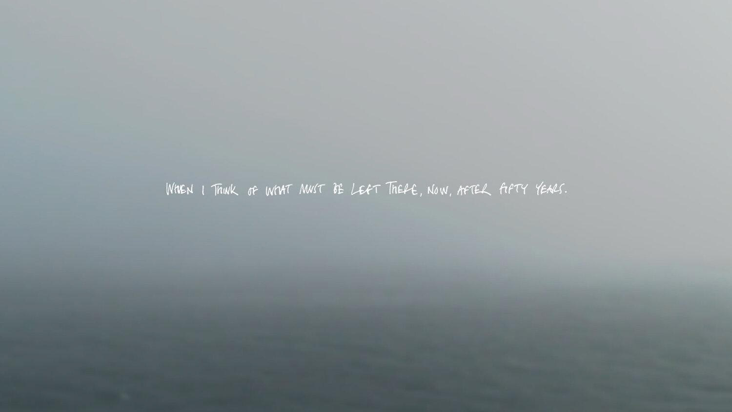 A screenshot of a foggy sea view with handwritten text superimposed, saying 'When I tink of what must be left there now, after fifty years