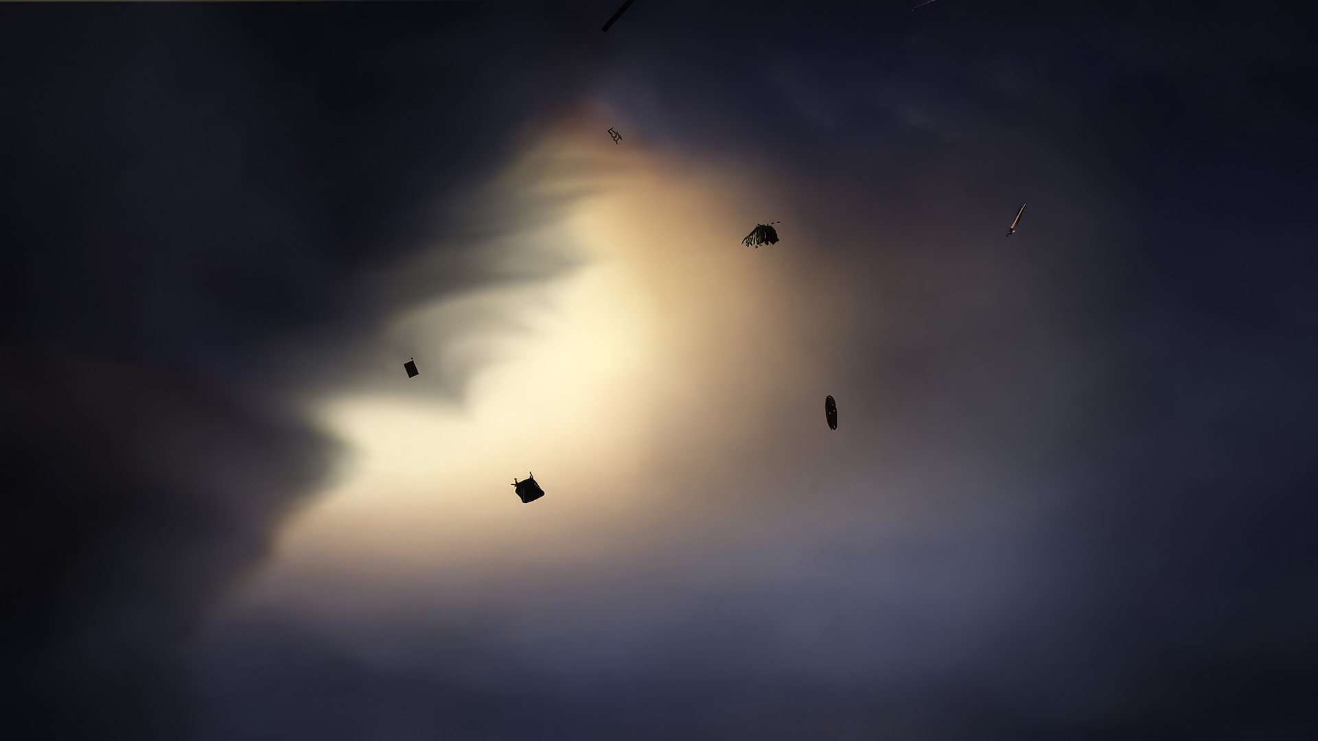 Find Your Way to Oz: a CG storm interior seen from below, with warm amber light glowing through dark roiling clouds and silhouetted debris, including boxes, a broom, and other objects, floating in the darkness.