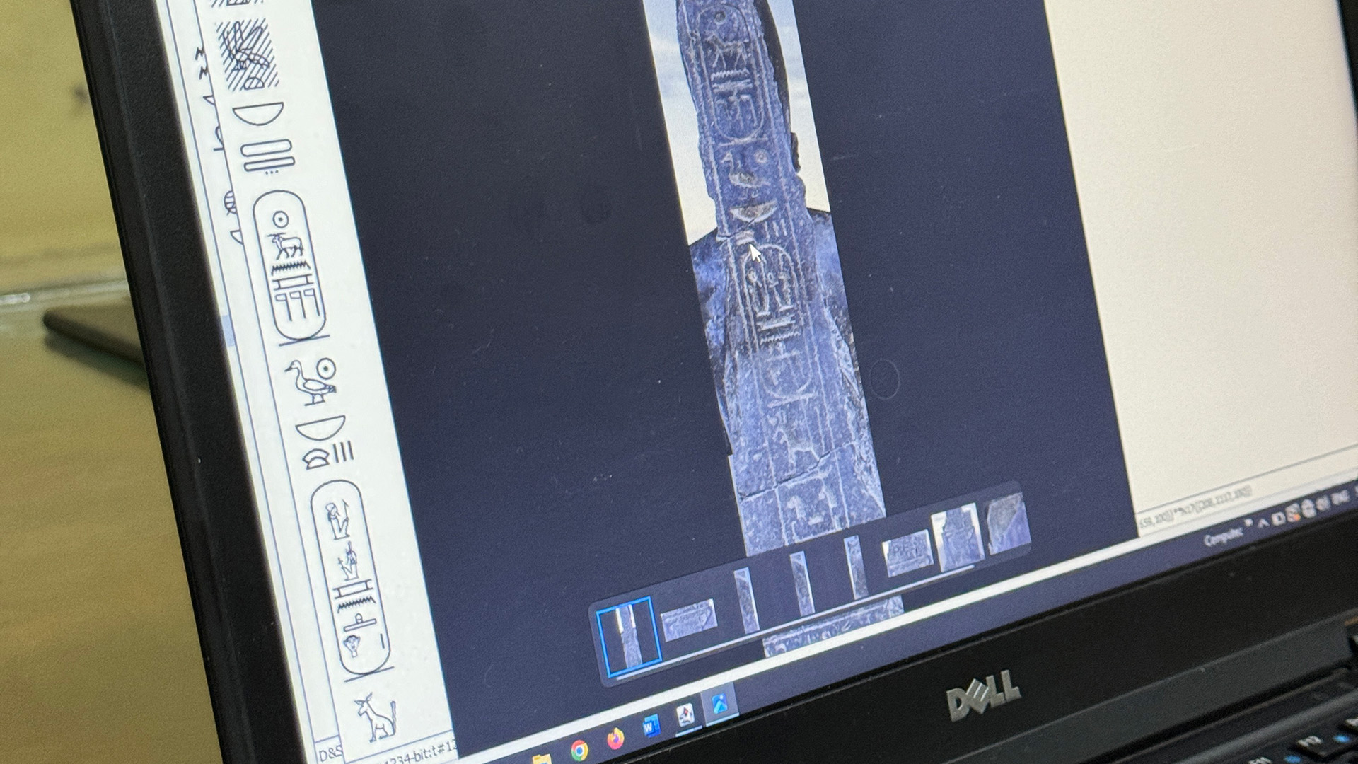 A close-up of a computer screen showing hieroglyph-labelling software analysing a carved obelisk fragment.