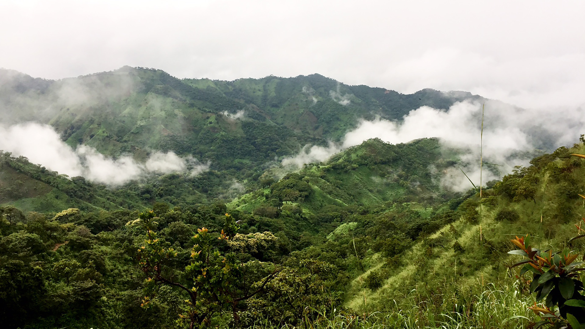 WATER: Mist rolling over green mountains in rural Honduras.